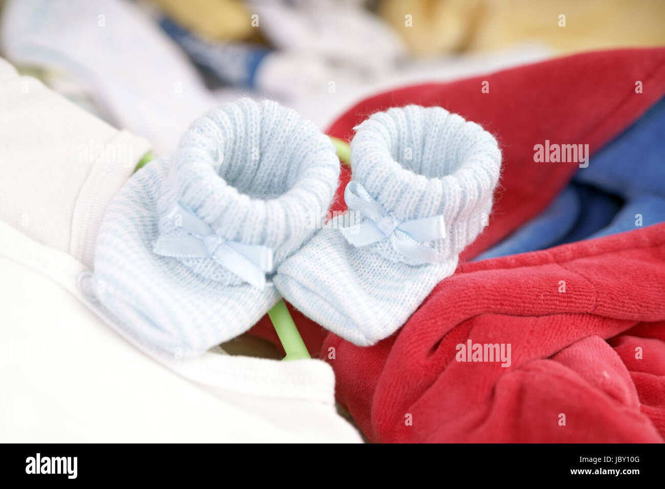 Baby shoes on a Baby bed Stock Photo Alamy