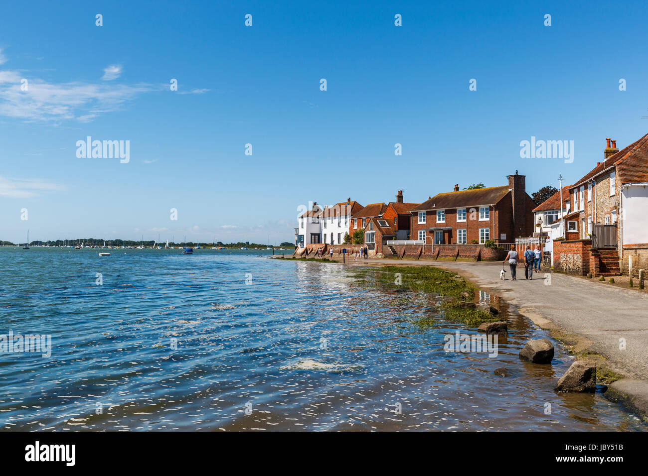Rising tide flooding the seafront access road, Bosham, a south coast coastal village in Chichester Harbour, West Sussex, southern England, UK Stock Photo