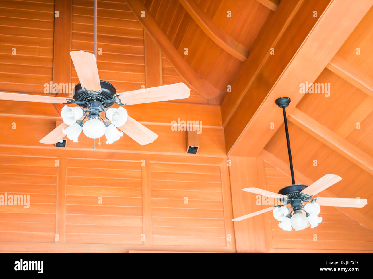 Old Style Wood Ceiling Fans With White Glass Lamps Stock Photo