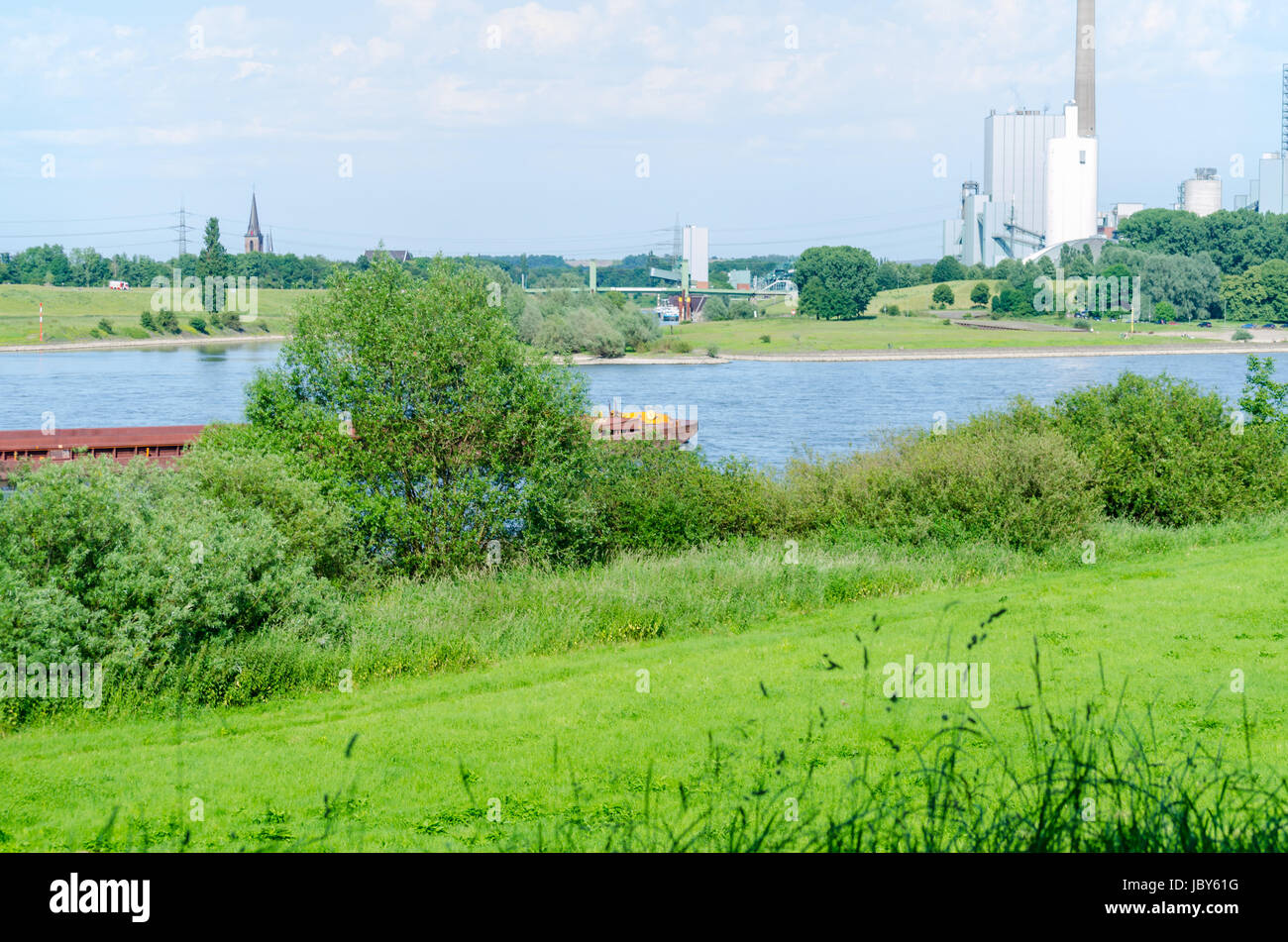 Schöne Rheinlandschaft mit Blick auf ein Kraftwerk in grüner Umgebung. Stock Photo