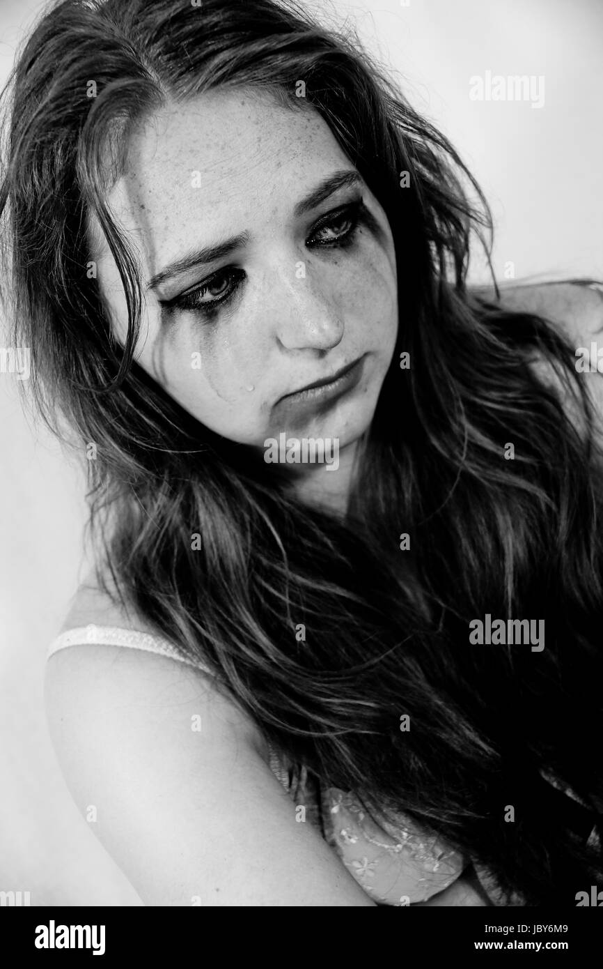 A young female model portrays distraught and distress on a photo shoot Stock Photo