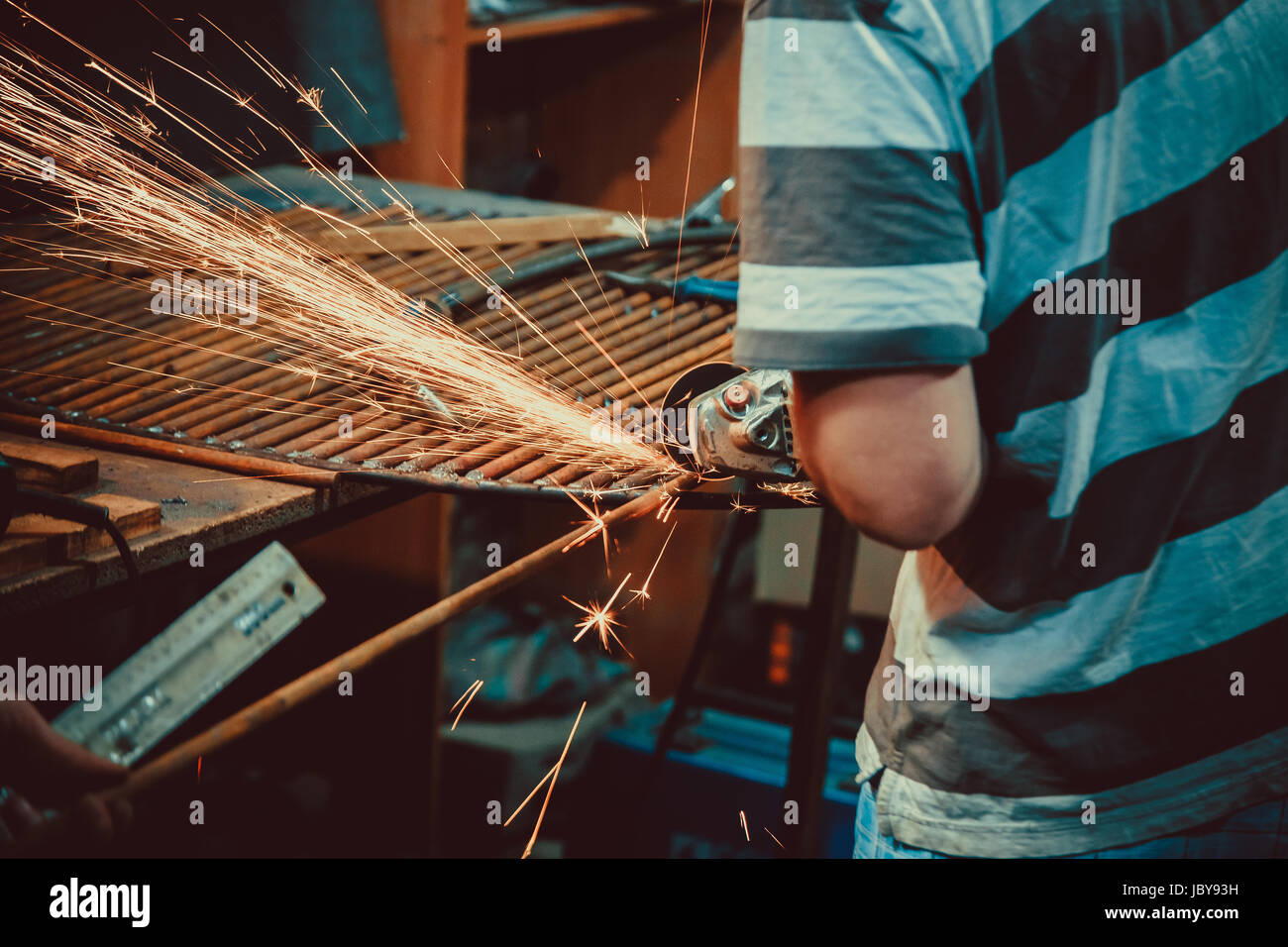 Sparks during cutting of metal angle grinder. Close-up saw sawing a steel. Soft focus. Shallow DOF. Stock Photo