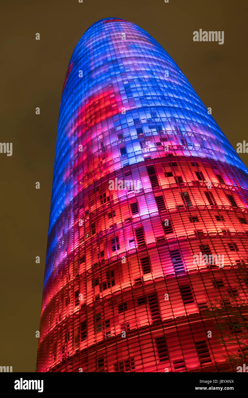 The Torre Agbar entrance at Diagonal, Barcellona, lite up at night in stumming colours. Stock Photo