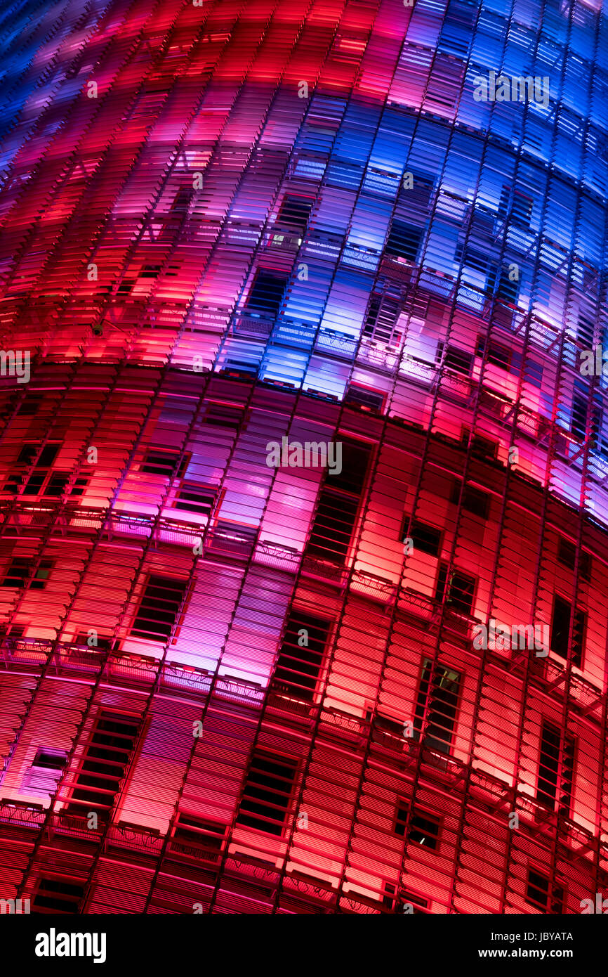 Close up of The Torre Agbar , Barcelona, lite up at night in stumming colours. Stock Photo