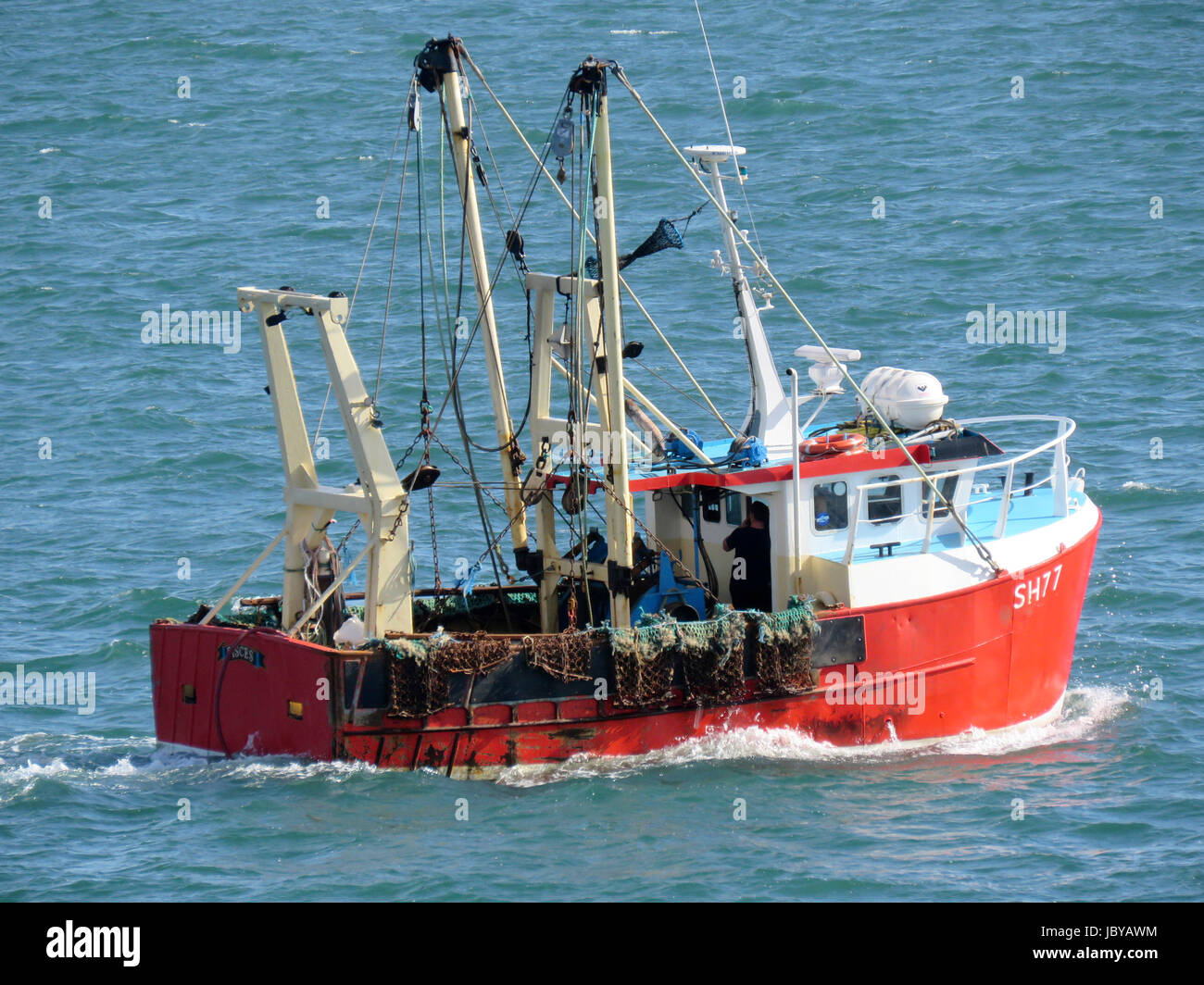 Red fishing boat trawler sailing in blue sea ocean on sunny day Stock ...