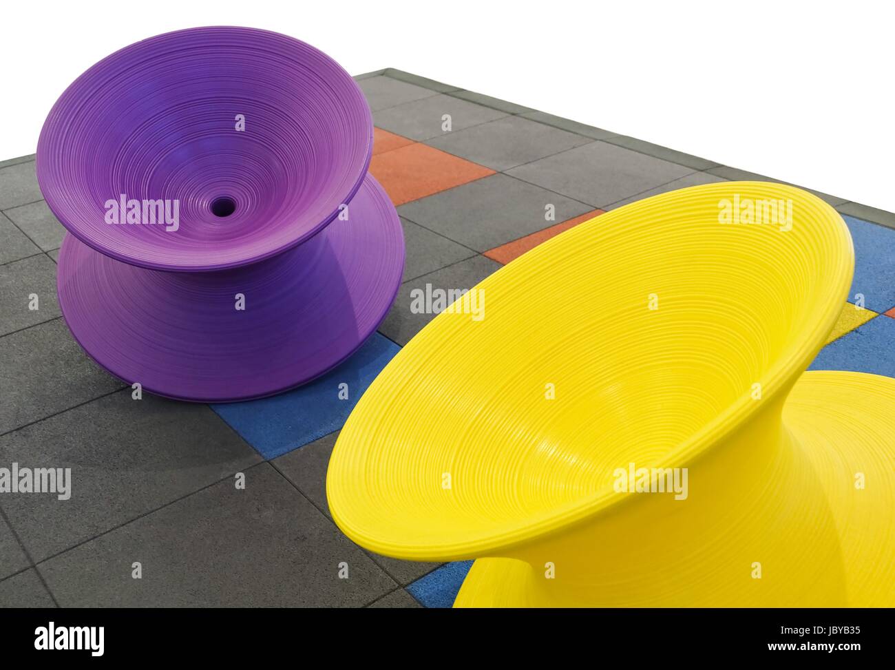 Giant Purple and Yellow Spinning Tops in The Children Playground Stock