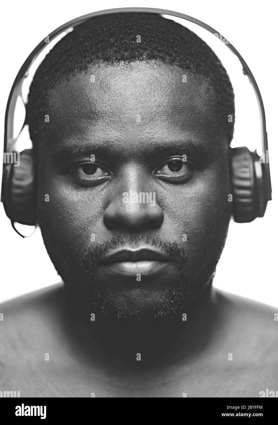 AfricanAmerican guy with headphones looking at camera in isolation