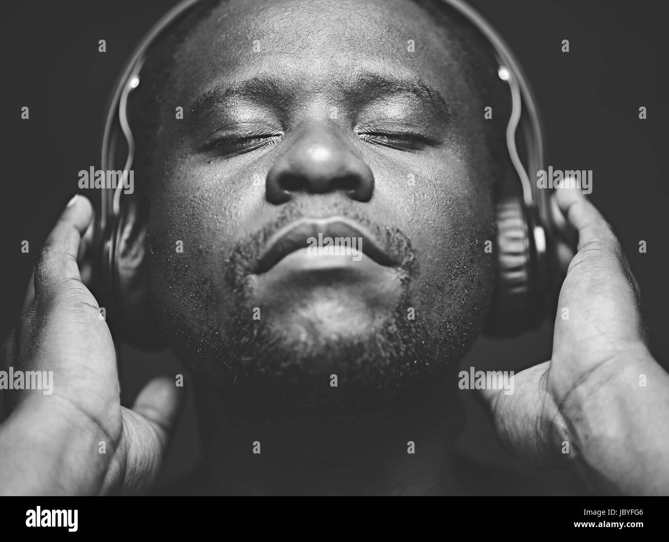 AfricanAmerican guy with headphones listening to his favourite music
