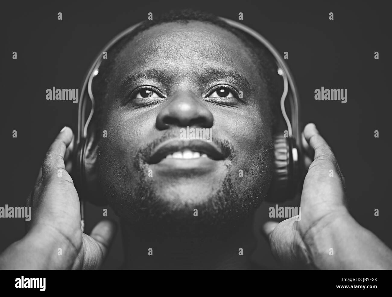 AfricanAmerican guy with headphones listening to his favourite music