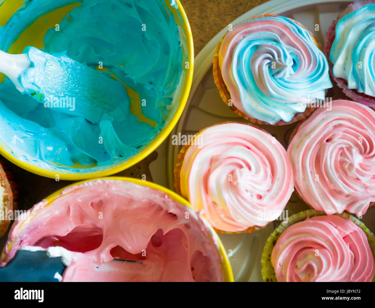 Cupcakes colorful cream muffin arrangement in golden mirror tray The concept of homemade baking and hospitality at home Stock Photo