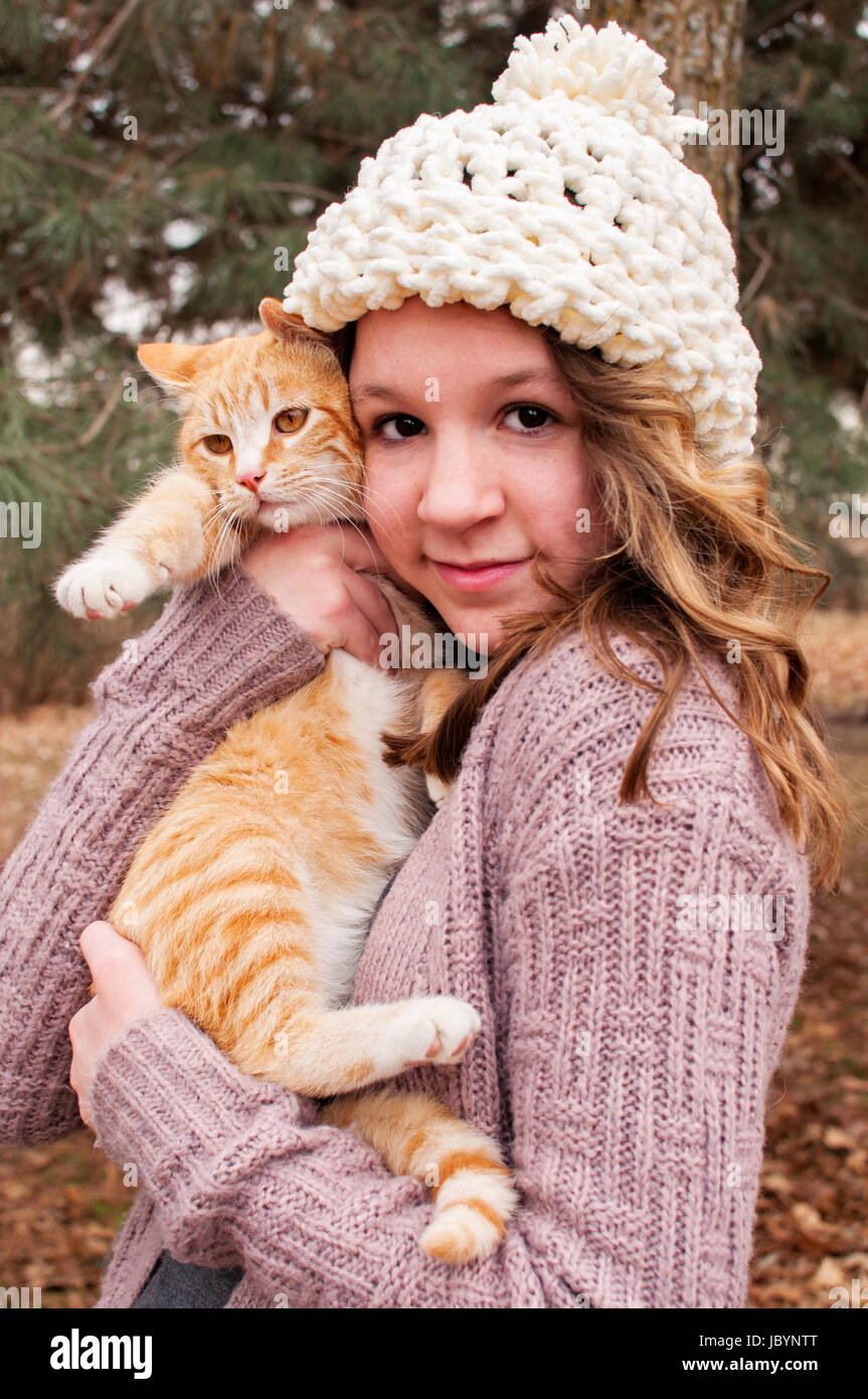 teenager holding cat Stock Photo