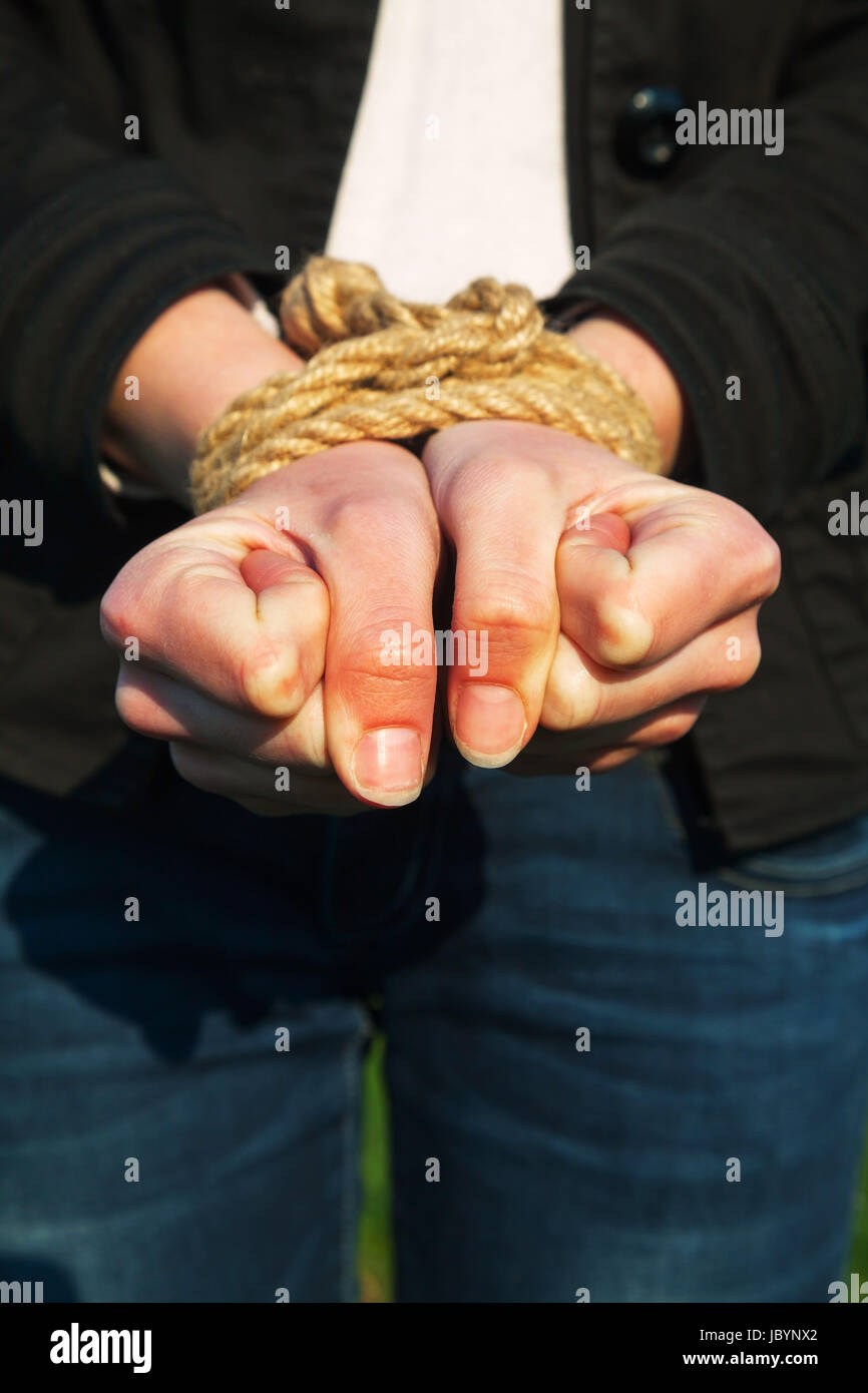 Female hands tied up with the rope Stock Photo Alamy