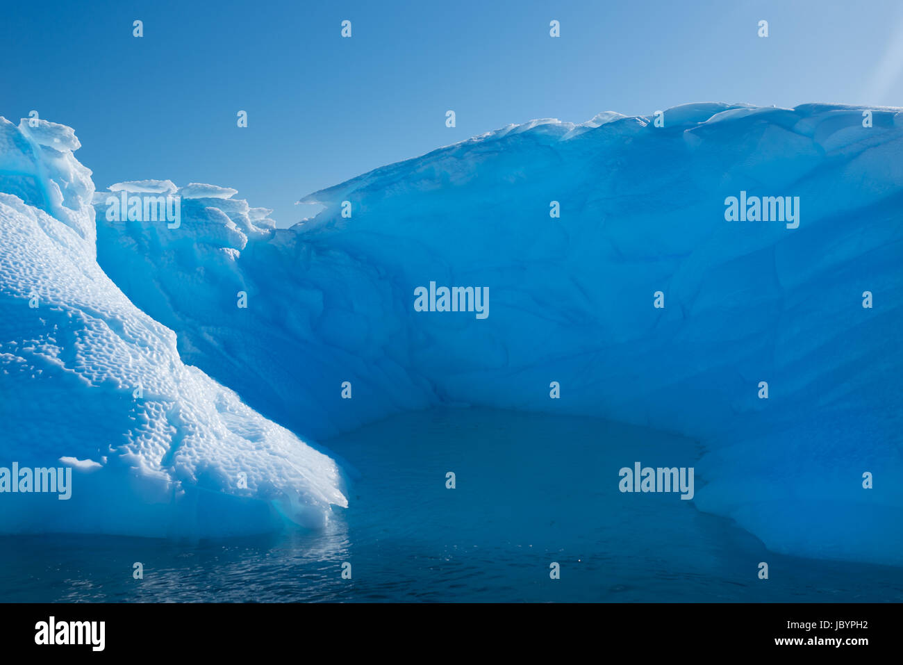 Blue shimmering beautiful iceberg in Antarctica Stock Photo