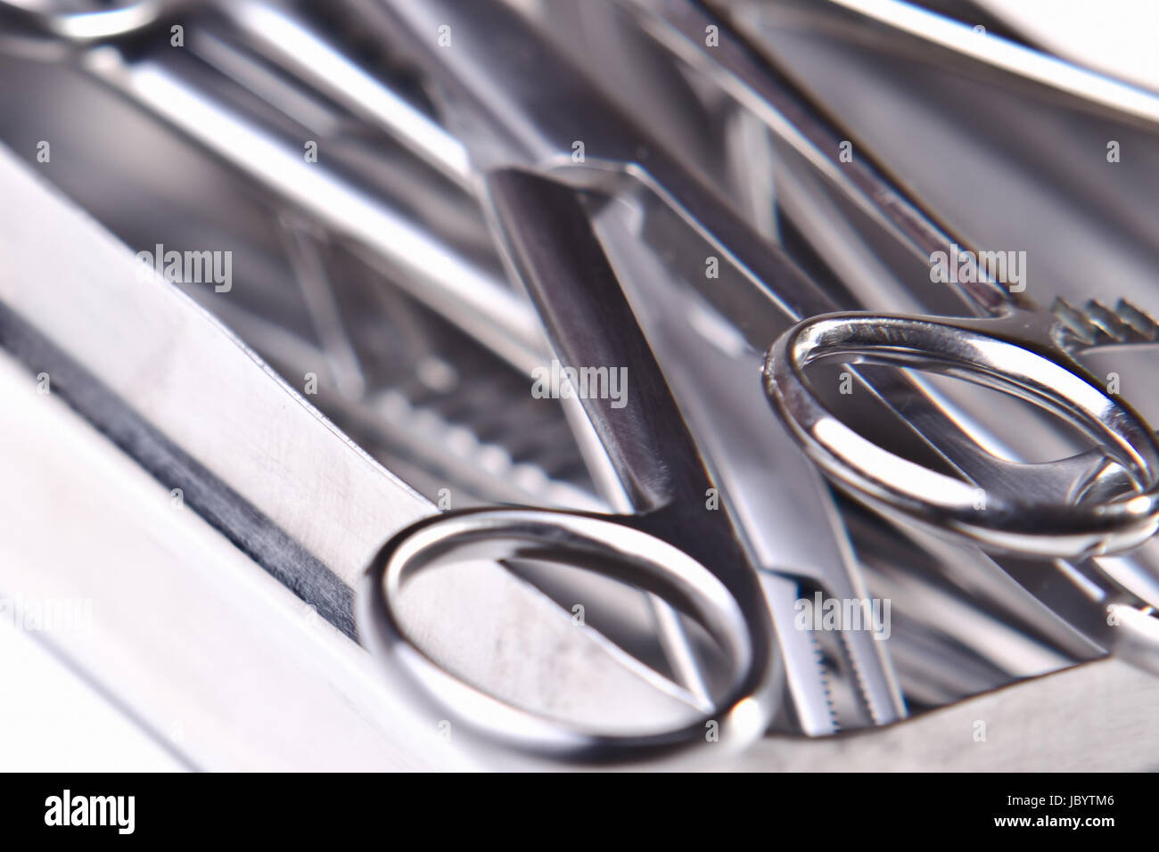 metallic shiny surgical instruments on white background Stock Photo - Alamy
