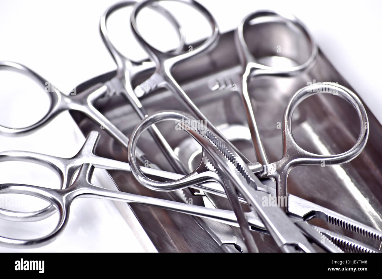 metallic shiny surgical instruments on white background Stock Photo - Alamy