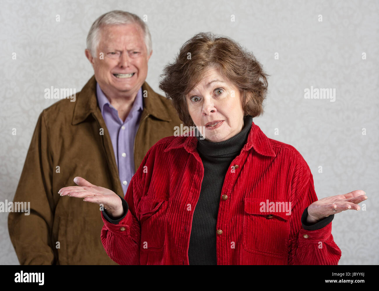Frustrated woman with hands up and angry man Stock Photo