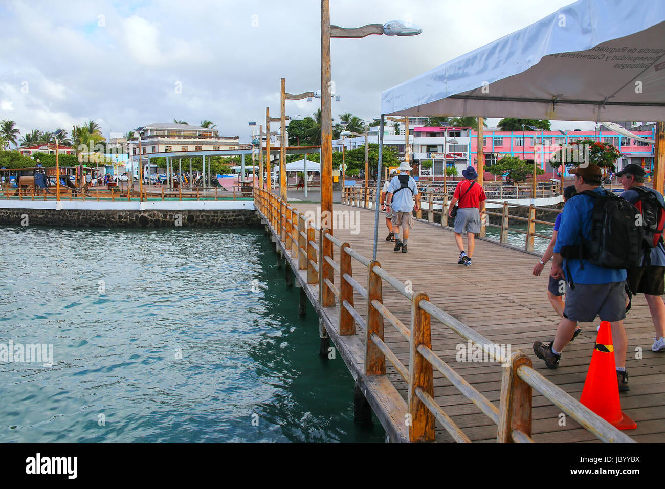People walking on the pier at Puerto Ayora on Santa Cruz Island, Galapagos National Park, Ecuador. Puerto Ayora is the most populous town in the Galap Stock Photo