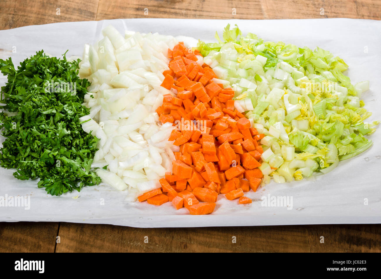 Ingredients for soup making with carrots, onions and celery chopped