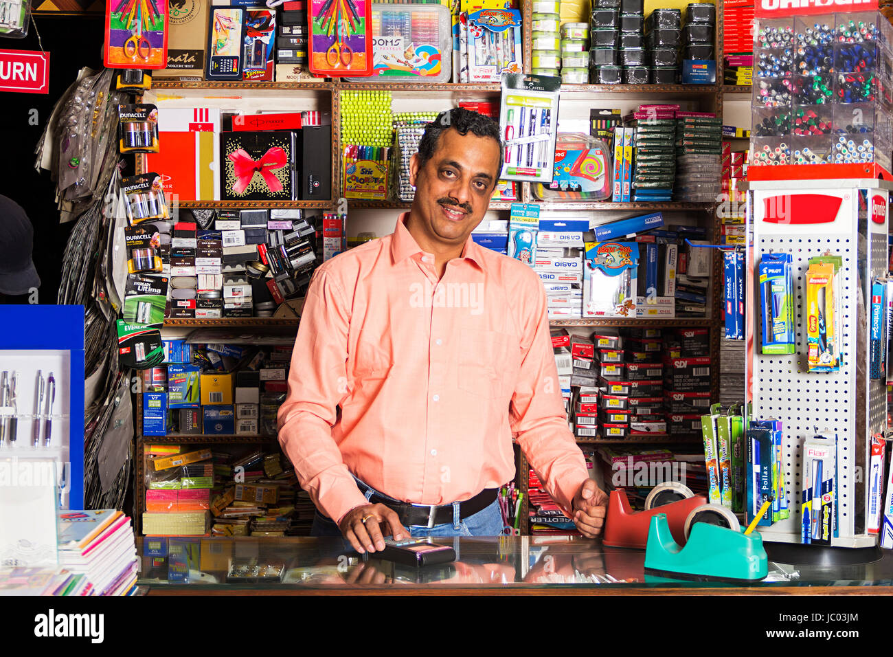 1 Shopkeeper Man Using Credit Card Reader In Stationery Shop Stock Photo