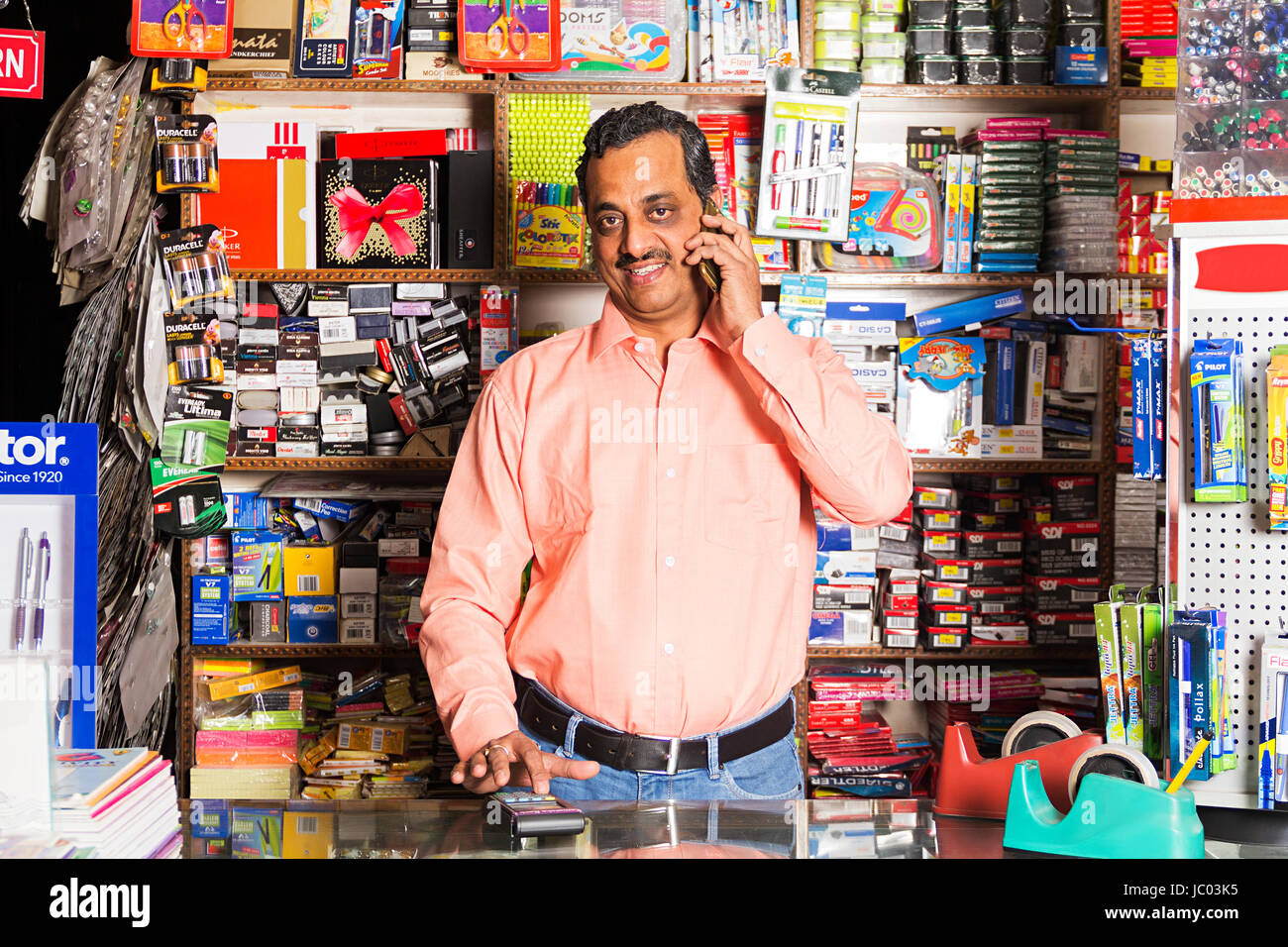 1 Shopkeeper Man Talking On Phone Stationery Shop Stock Photo