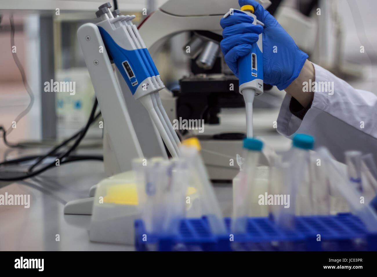 Modern scientist working in biotechnological laboratory equipment for ...