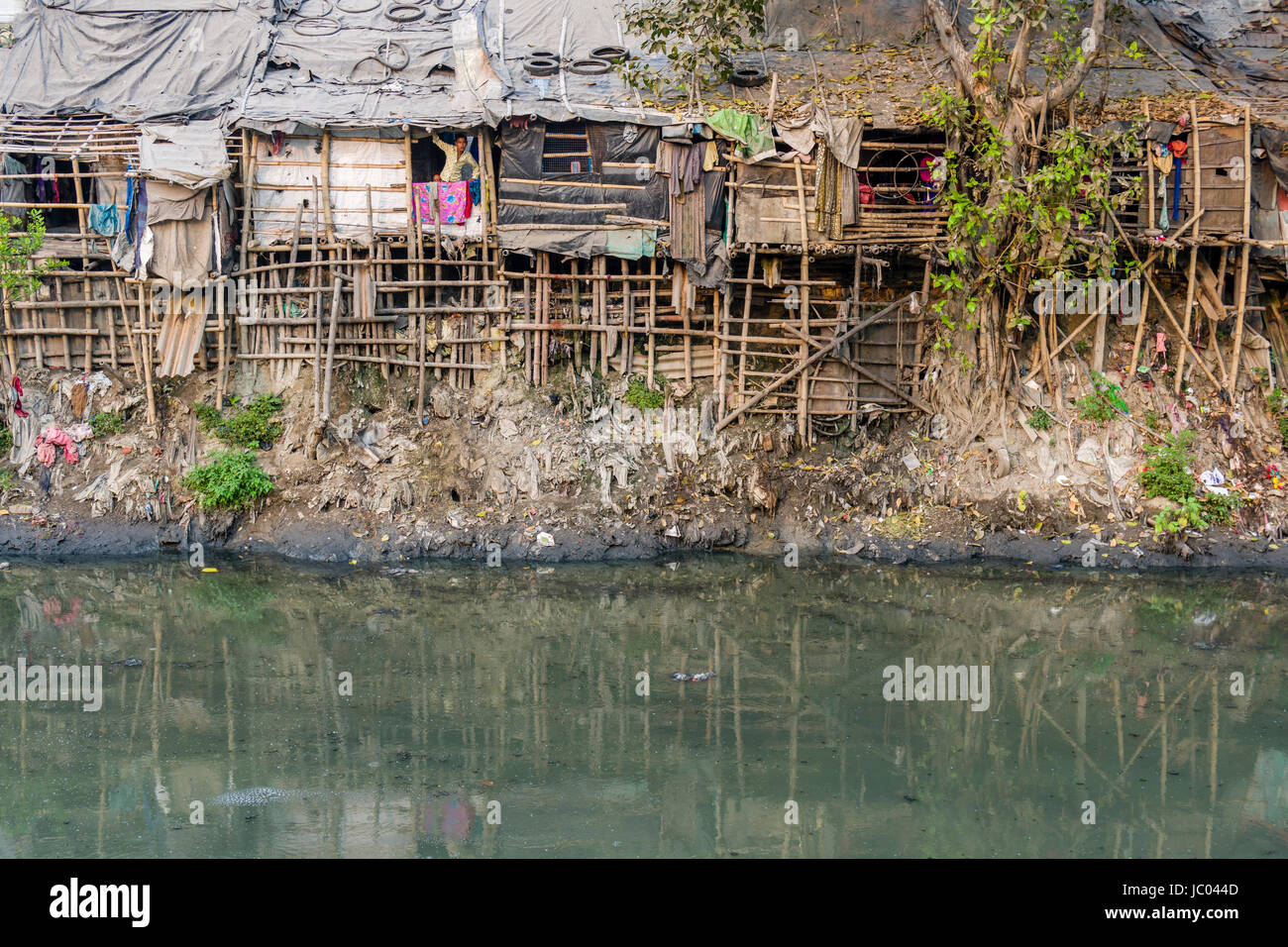 The dwellings and huts in Topsia slum are located at a dirty river Stock Photo