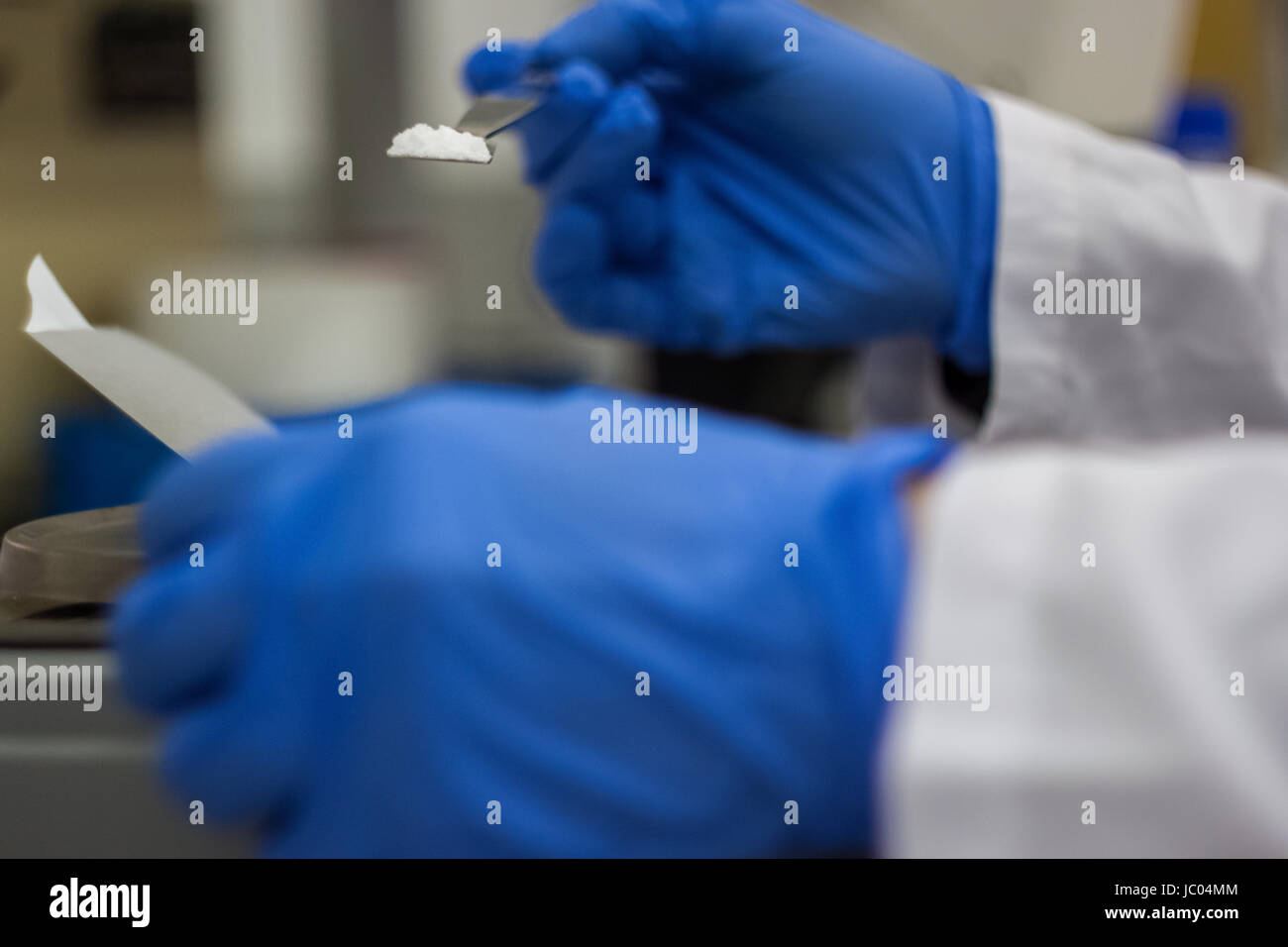 Scientist phd student taking from balance scale DNA samples from litmus ...