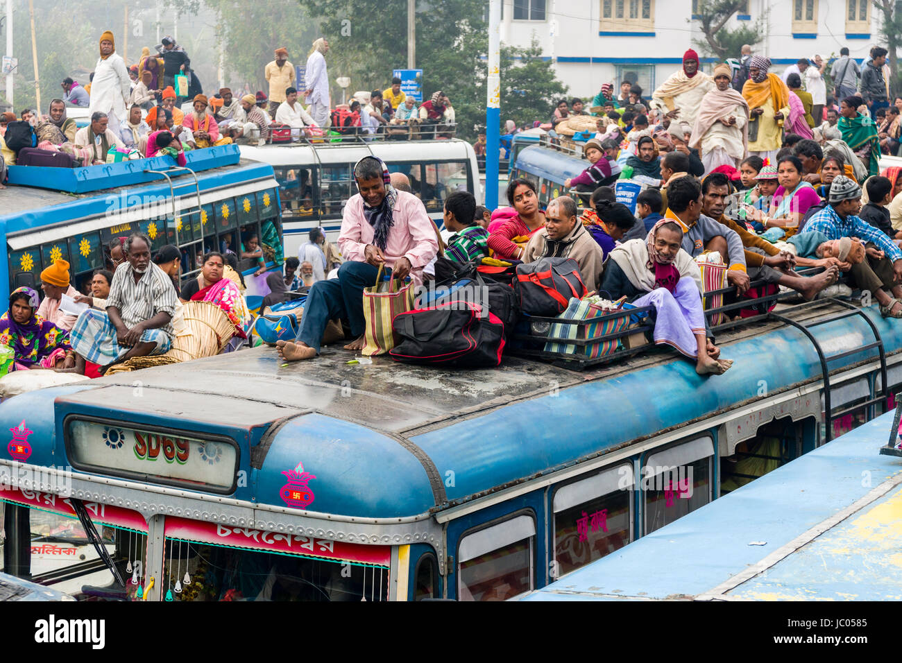 Busses full with pilgrims at the bus stop in Ganga Sagar are ready to leave for the jetty in Kakdwip Stock Photo