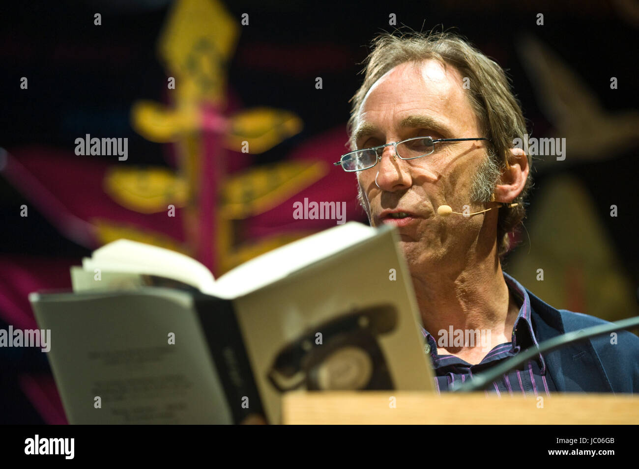 Will Self novelist reading from his novel Phone on stage at lectern during Hay Festival 2017 Hay-on-Wye Powys Wales UK Stock Photo