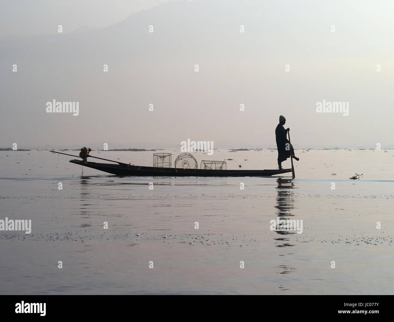 Silhouette of traditional fisherman on Inle lake Myanmar Stock Photo ...