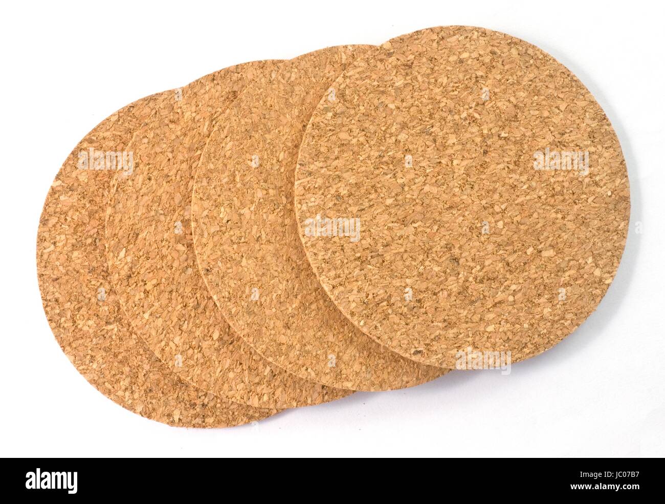 Background Pattern, Four Brown Round Cork Coasters Isolated on A White Background. Stock Photo