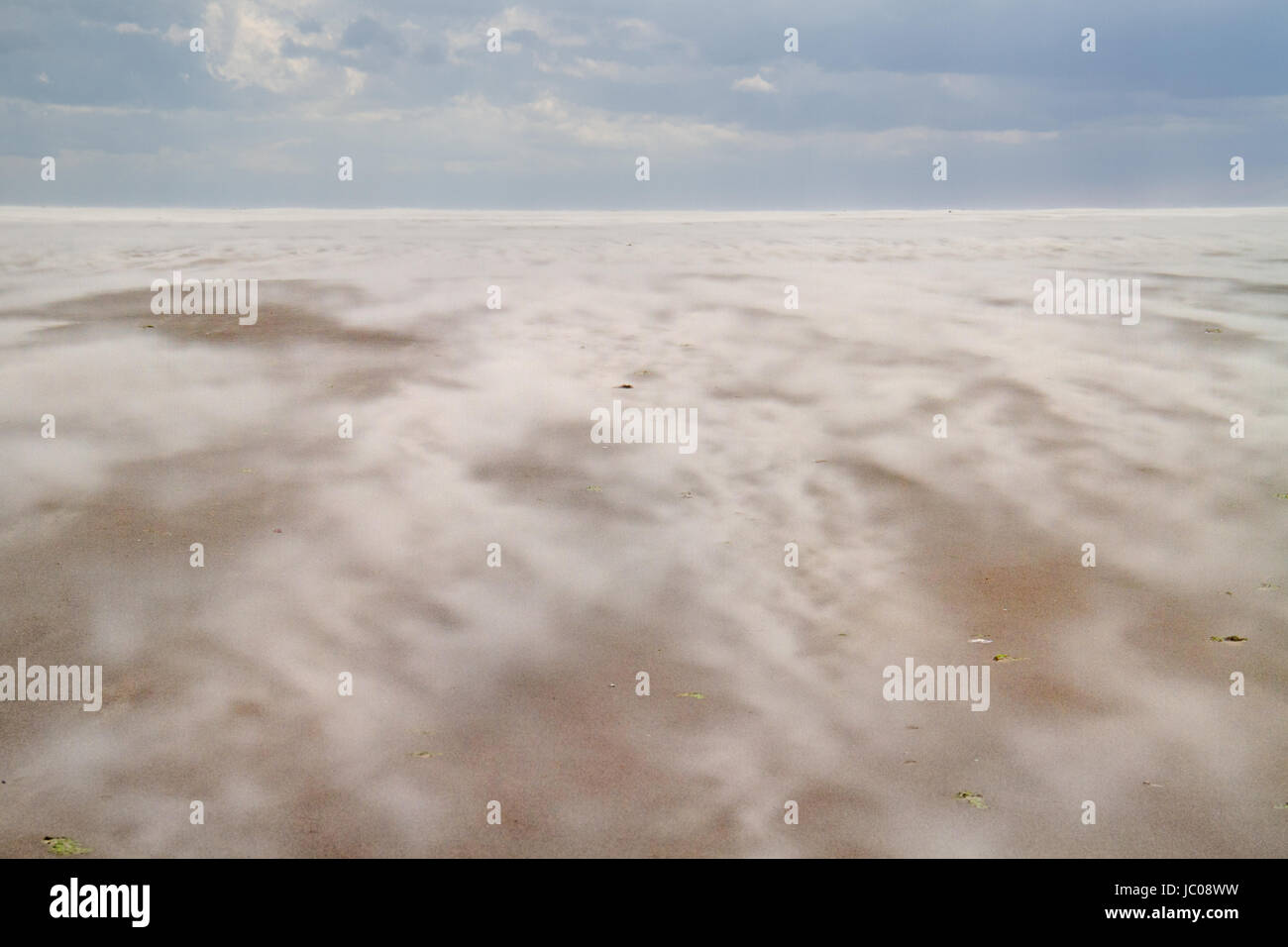 Shifting sand on a beach on a stormy day Stock Photo