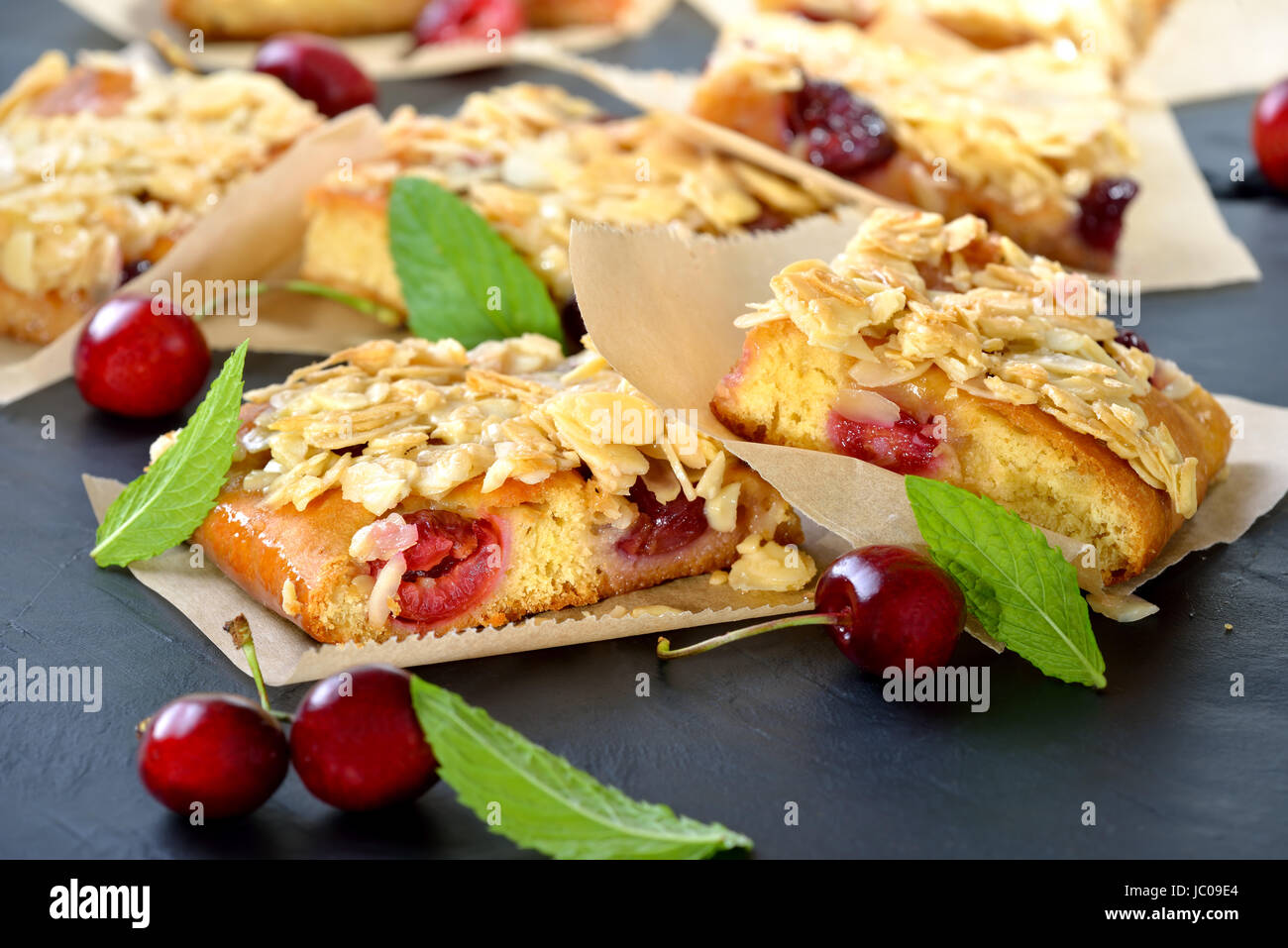 Yeast cake with fresh cherries  and crunchy almond caramel Stock Photo