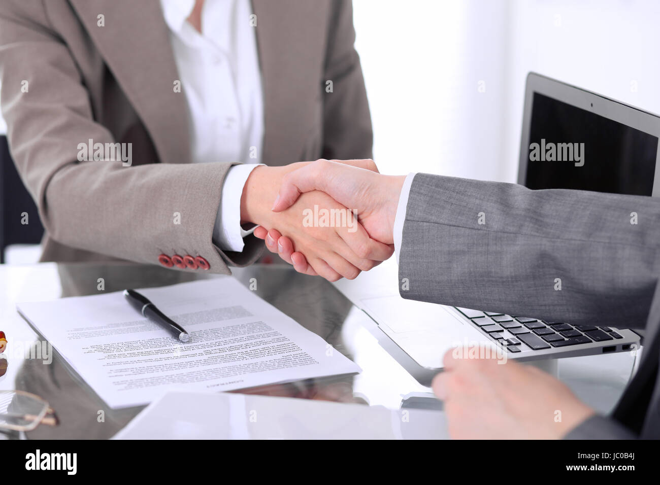Business handshake. Two women lawyers are shaking hands after meeting or  negotiation.  Stock Photo