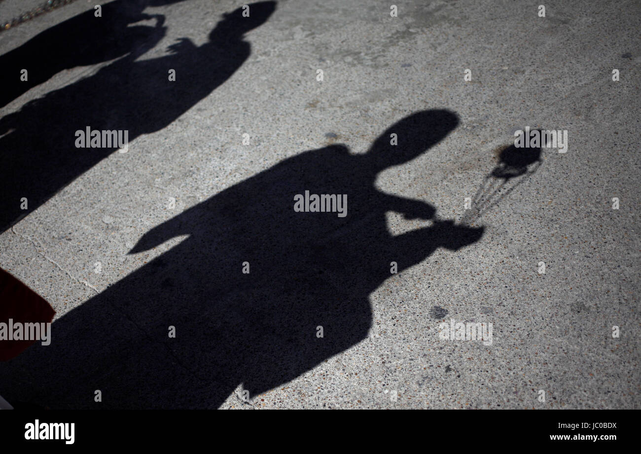 The shadow of altar boys spreading incense is seen during Easter Week