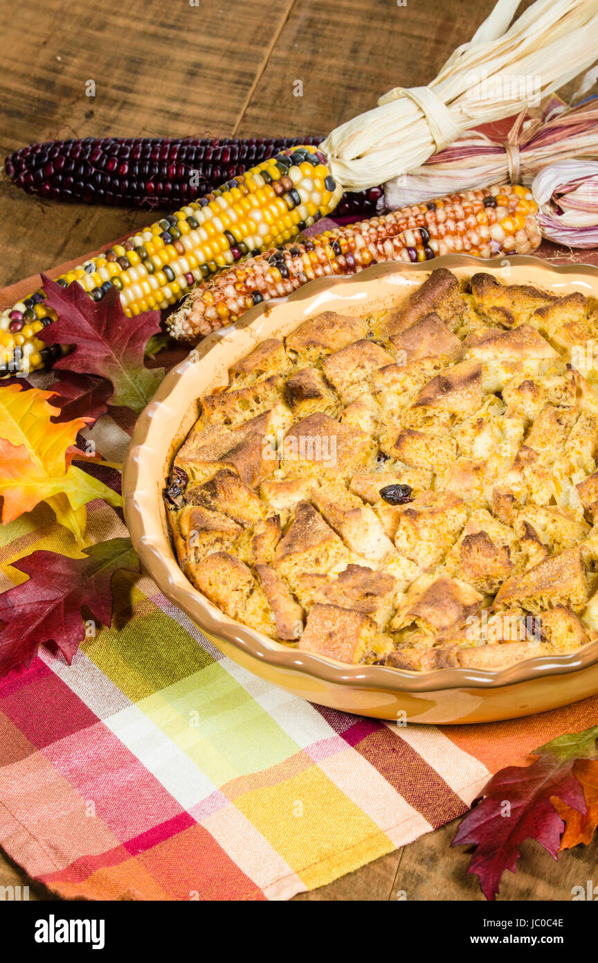 A bread pudding with raisins desert with fall or Thanksgiving decorations Stock Photo