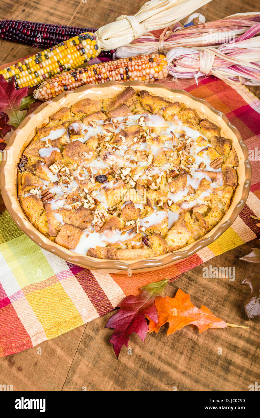 A bread pudding with raisins desert with fall or Thanksgiving decorations Stock Photo