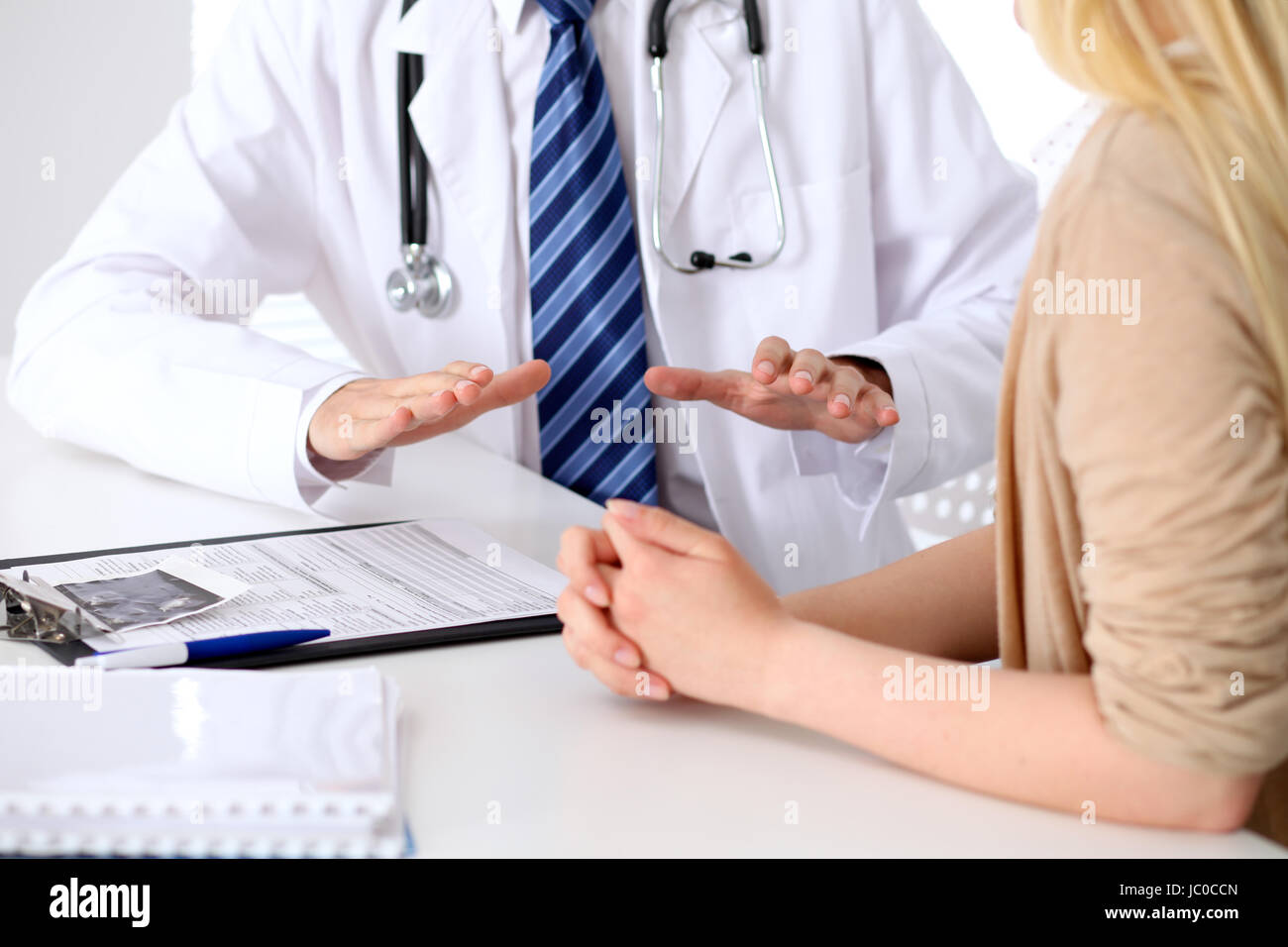 Trusting A Doctor Hand of doctor reassuring her female patient. Medical ethics and trust ...