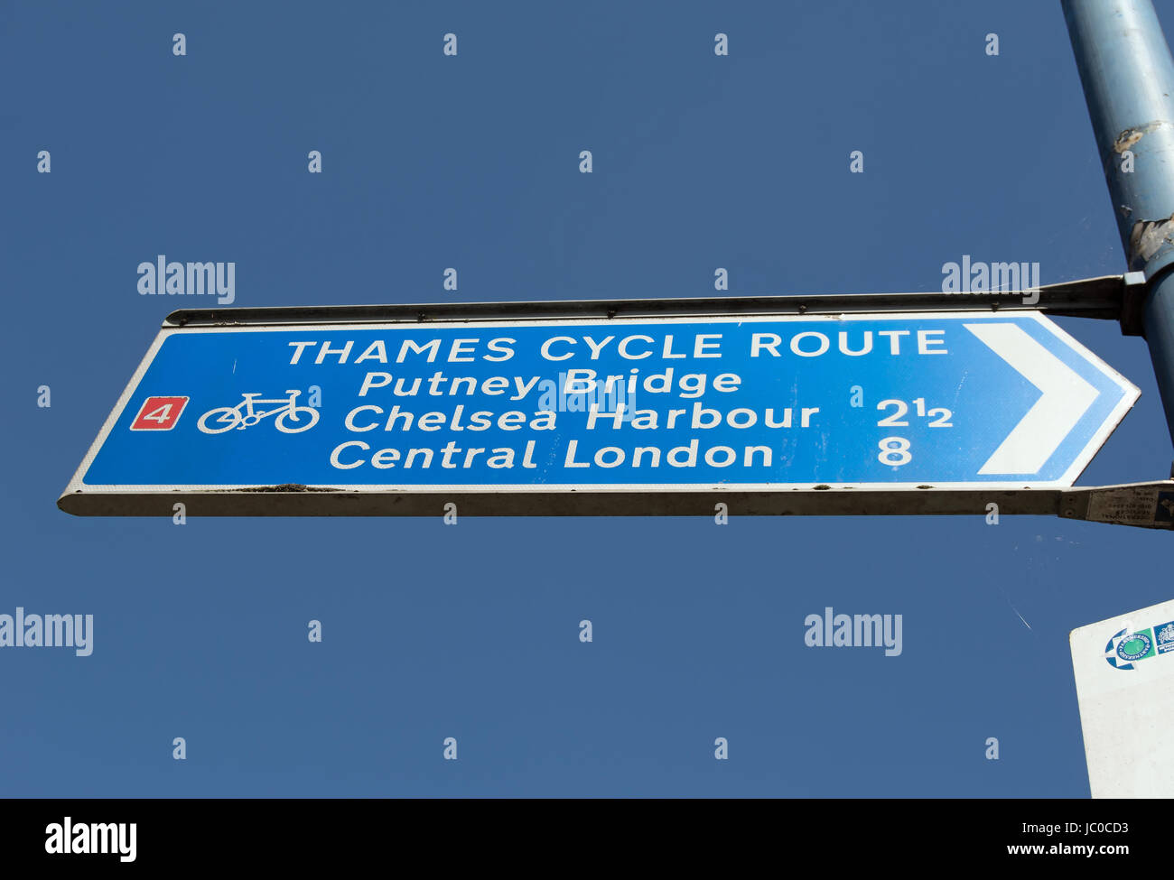 right pointing cycle route sign giving directions and distances to putney bridge, chelsea