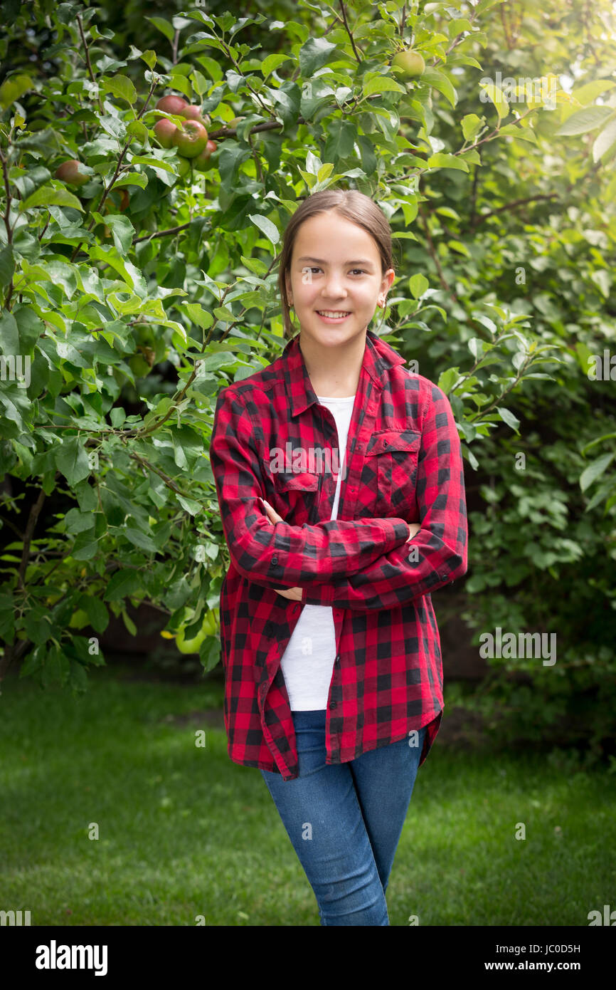 Portrait of beautiful smiling teenage girl posing at garden Stock Photo ...
