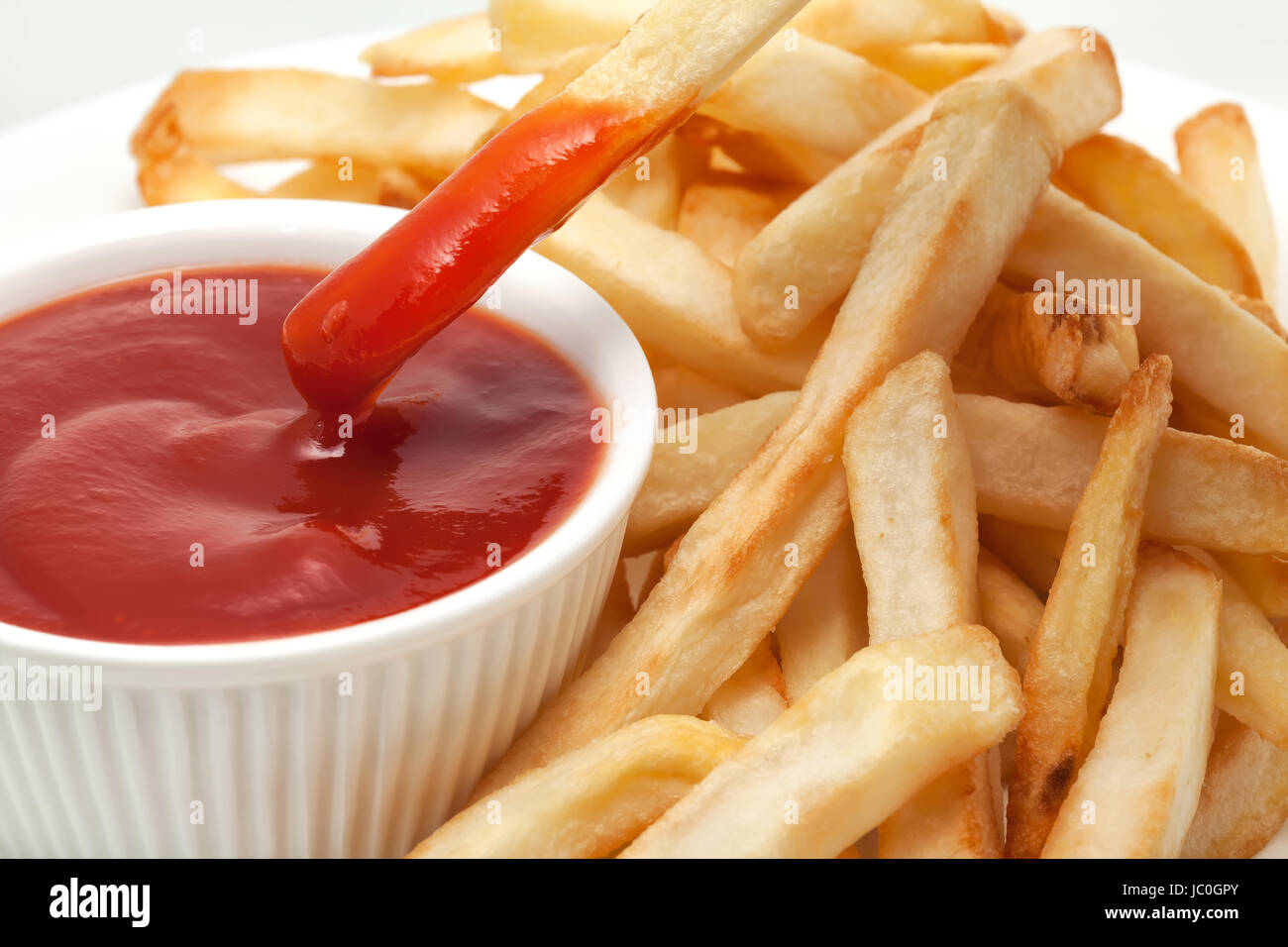 Ketchup with french fries dipped Stock Photo Alamy