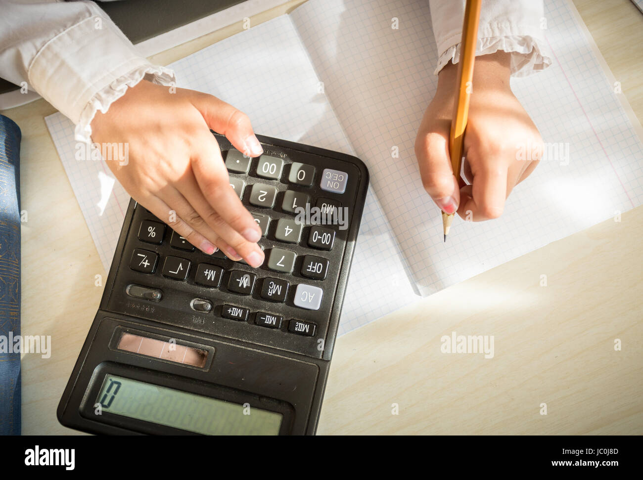 Closeup shot of girl solving maths task on calculator Stock Photo - Alamy