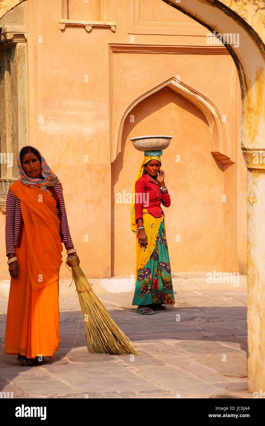 Local women working in the fourth courtyard of Amber Fort, Rajasthan, India. Amber Fort is the main tourist attraction in the Jaipur area. Stock Photo