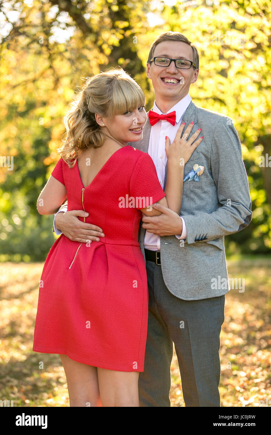 Portrait of happy romantic couple hugging at park Stock Photo - Alamy