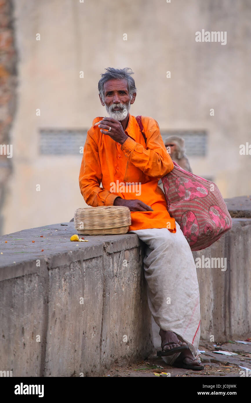 Local snake charmer sitting in the street of Jaipur, India. Jaipur is the capital and largest city of the Indian state of Rajasthan. Stock Photo