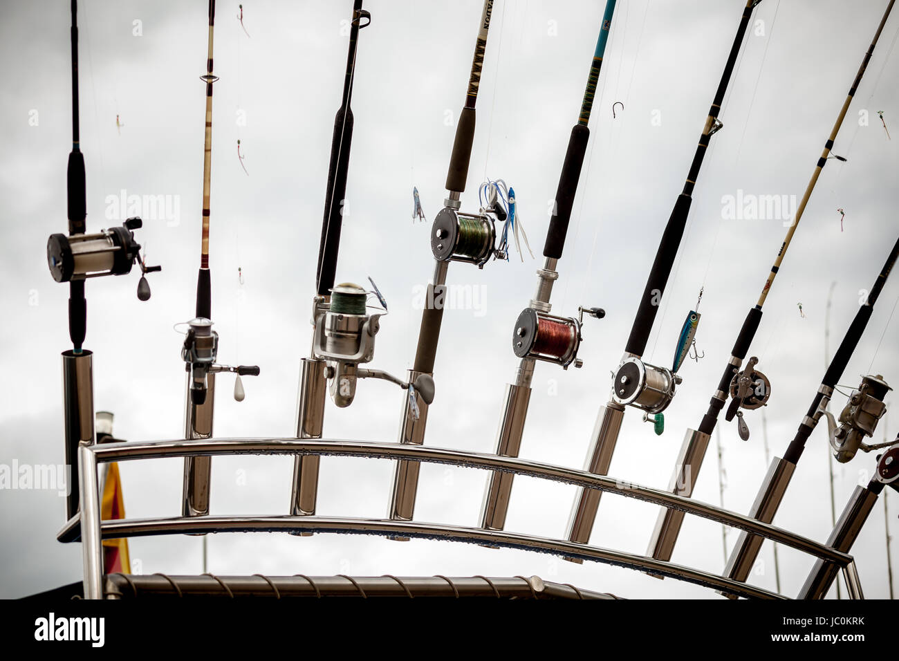 Closeup photo of row of fishing rods on ship Stock Photo