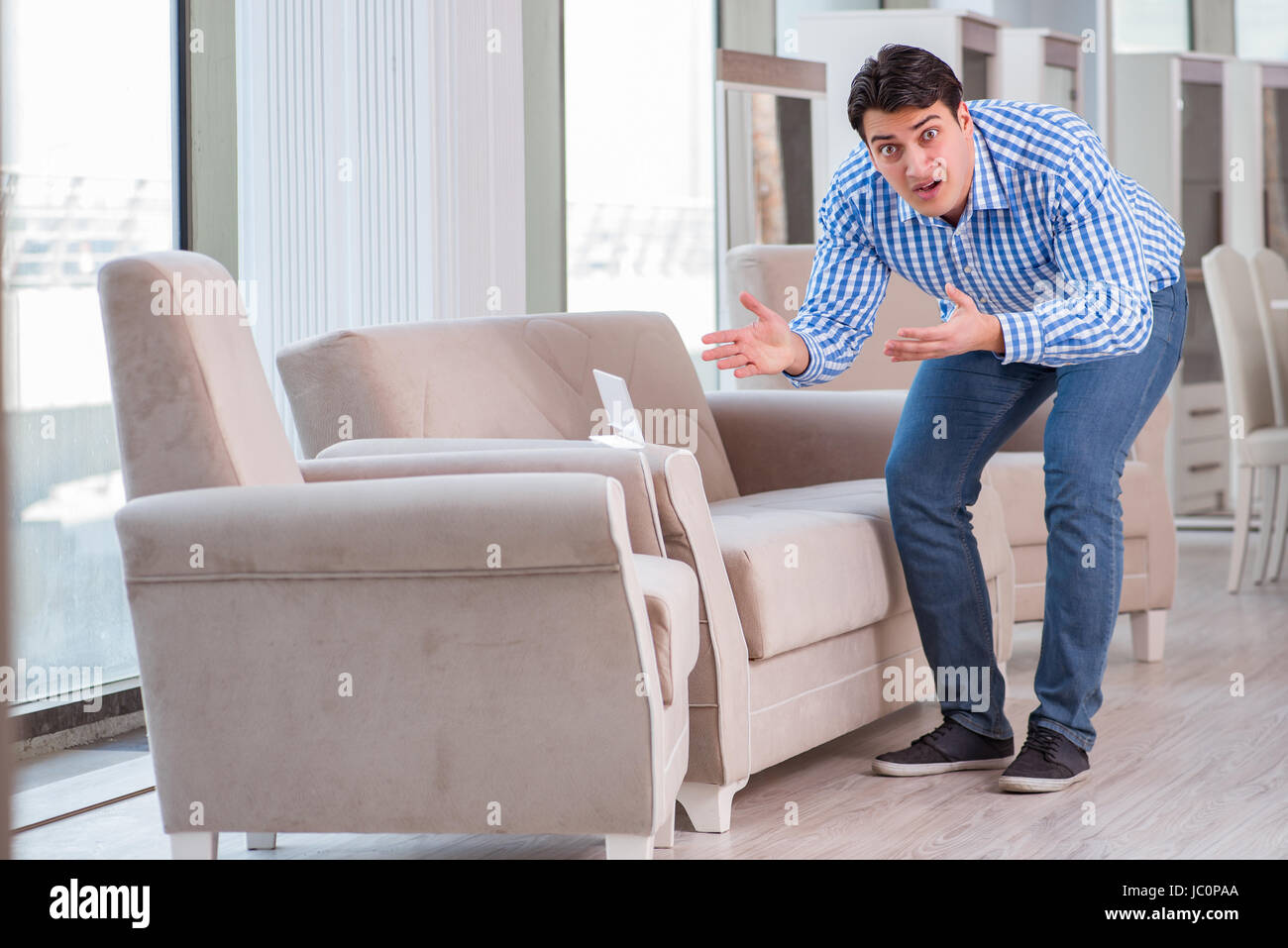 Young man shopping in furniture store Stock Photo - Alamy