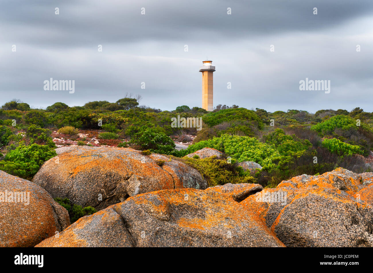 Cape Donington Lighthouse under dark clouds. Stock Photo