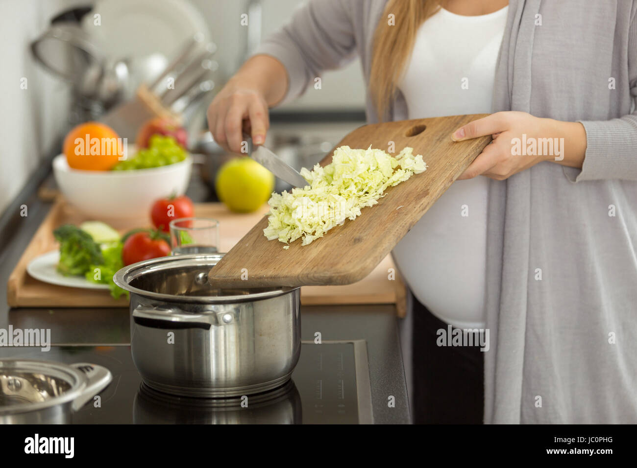 Closeup photo of pregnant woman cooking vegetable soup Stock Photo Alamy
