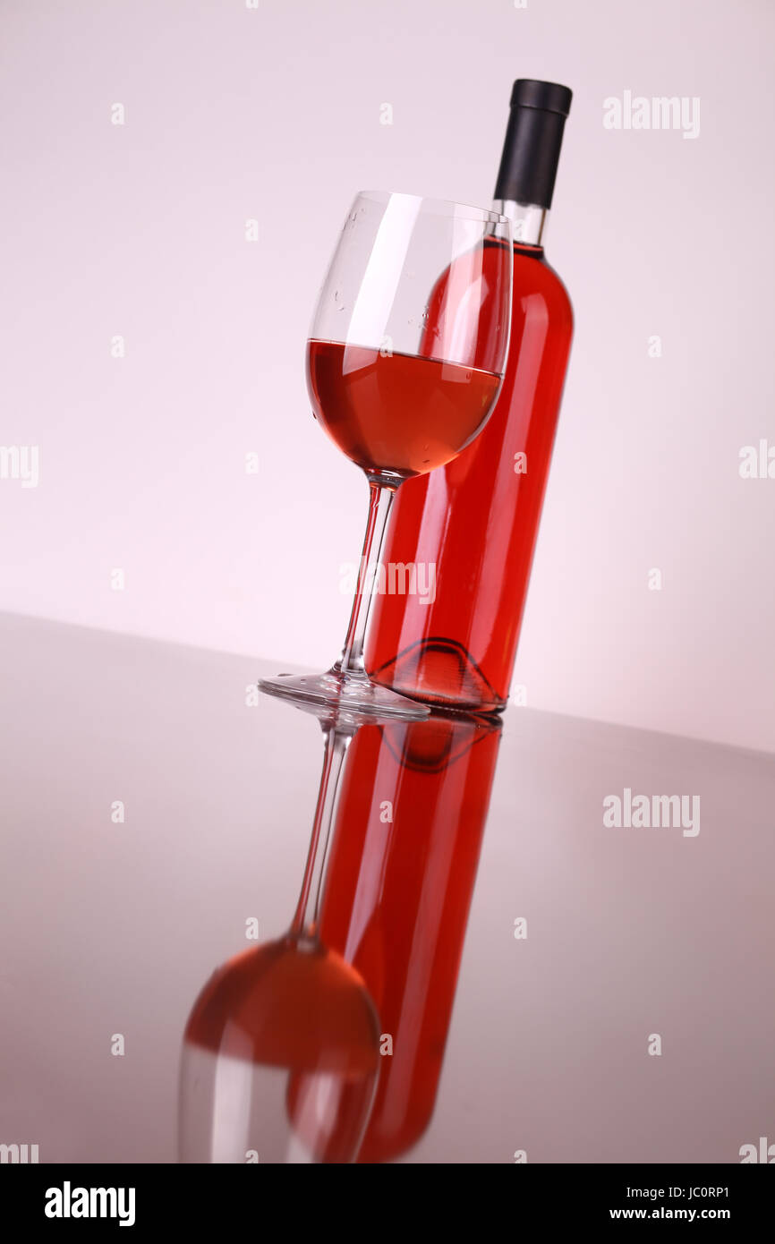 Glass and bottle of rose wine over a white background Stock Photo Alamy